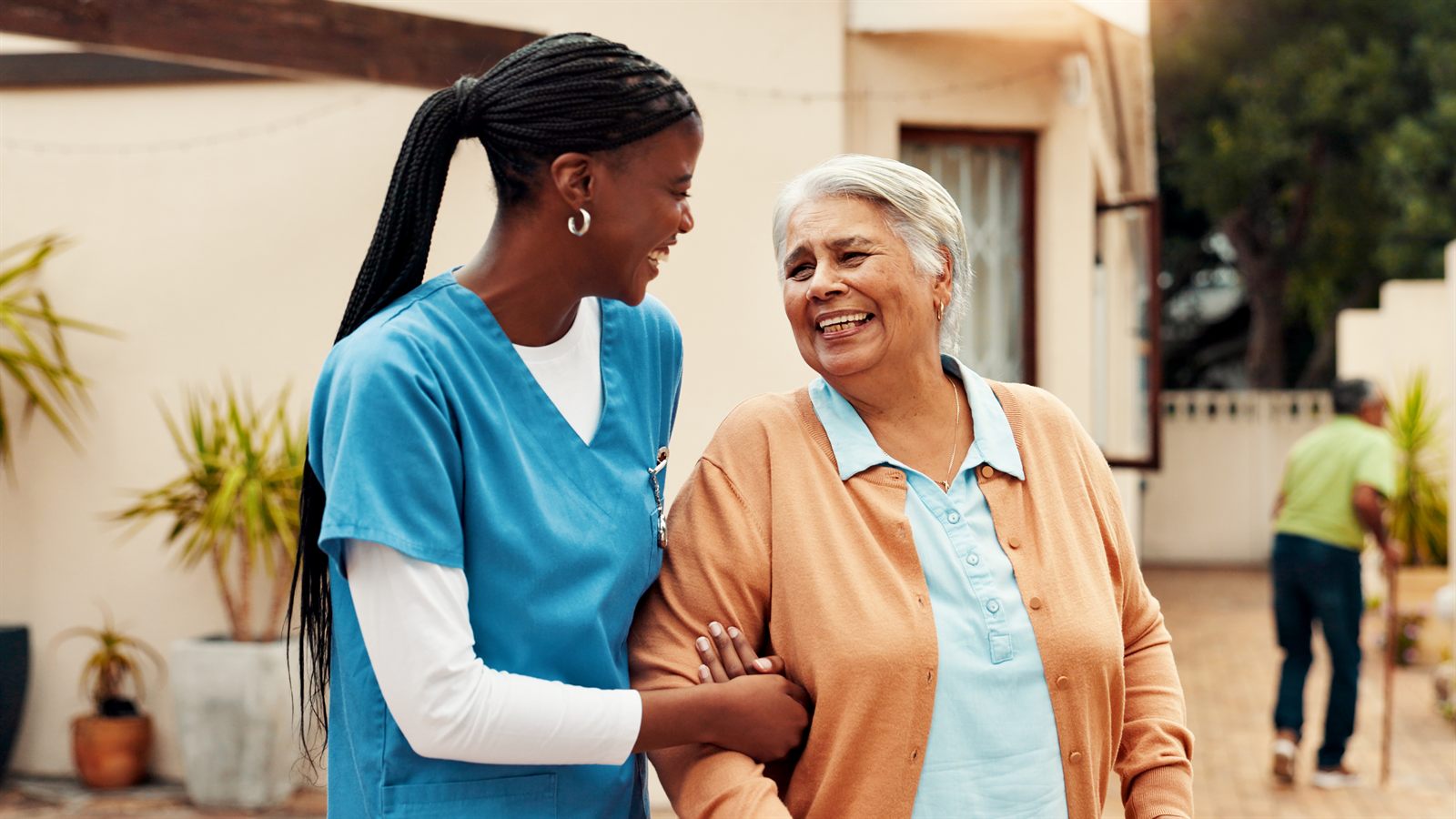 A nurse walking with a resident