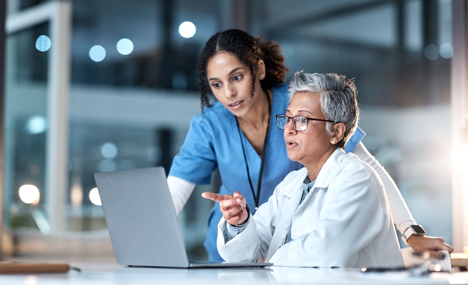 A nurse and administrator reviewing candidates